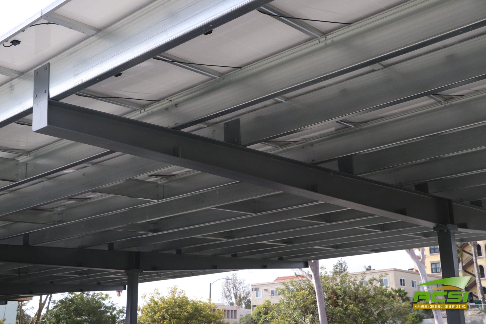 Structural solar canopy over a parking garage deck